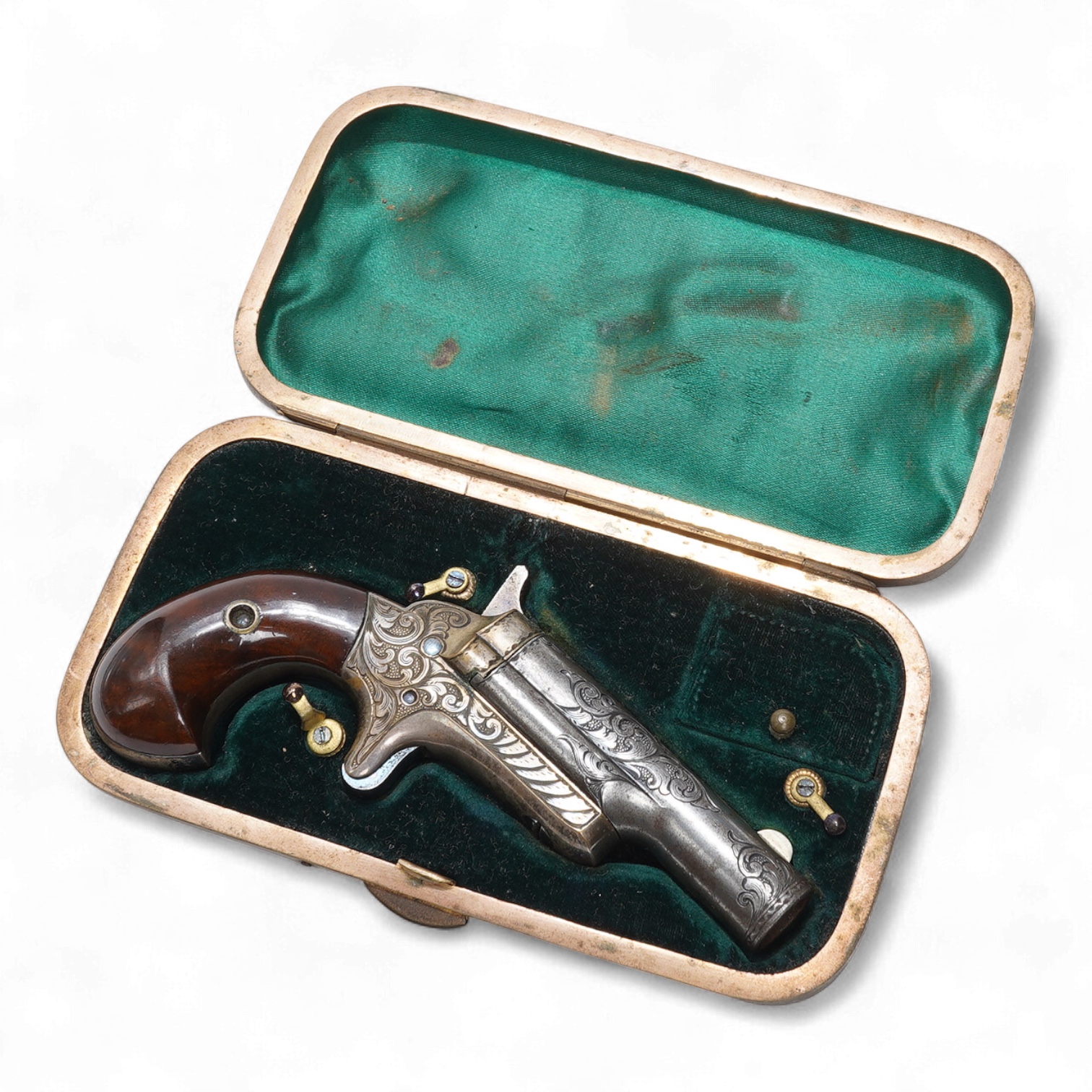A cased 0.41 of an inch Colt single shot Deringer type rimfire pistol with foliate engraved frame and barrel, London proof marks two-piece polished walnut grips, in its contemporary ‘cigar case’ housing with green velvet